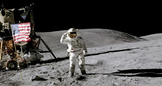Lunar Module Pilot Charles Duke salutes the flag